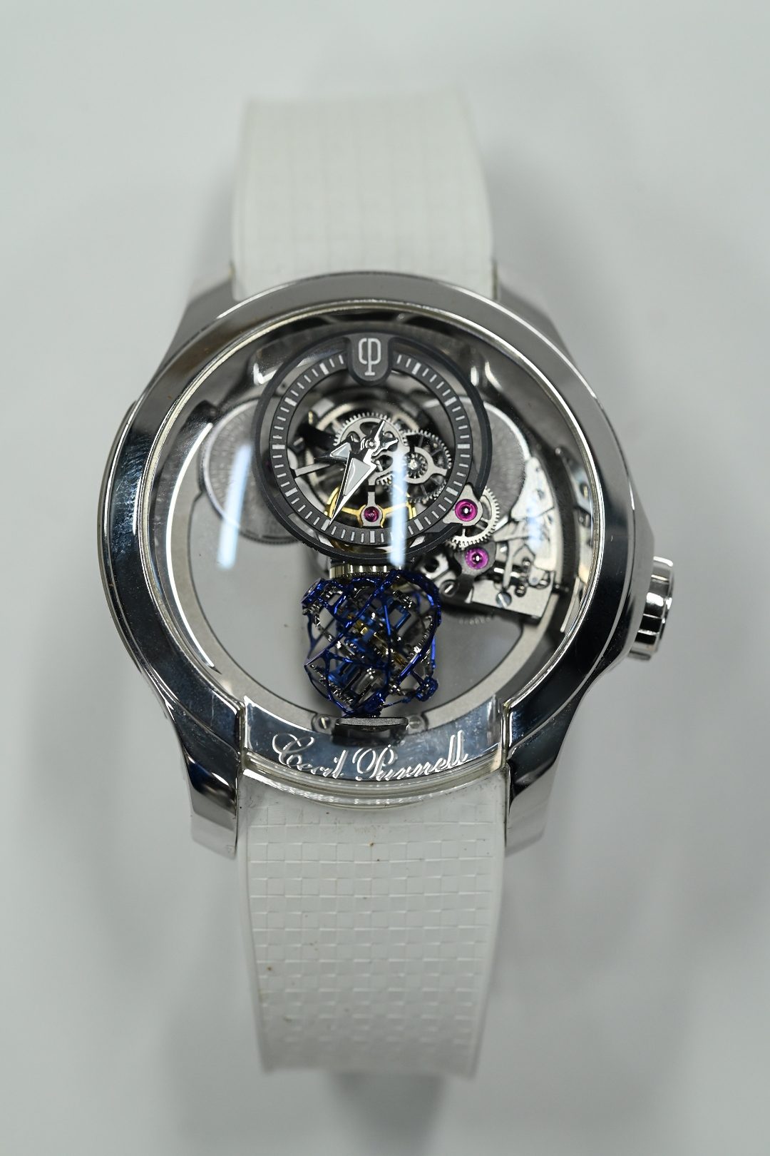 Cecil Purnell tourbillon in white metal, the blued spherical tourbillon cage suspended below a floating hours dial on a white rubber strap