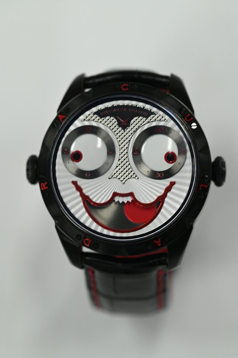 Konstantin Chaykin Joker in blackened steel, the dial reading as a face with regulator eyes and a red lacquer moonphase mouth